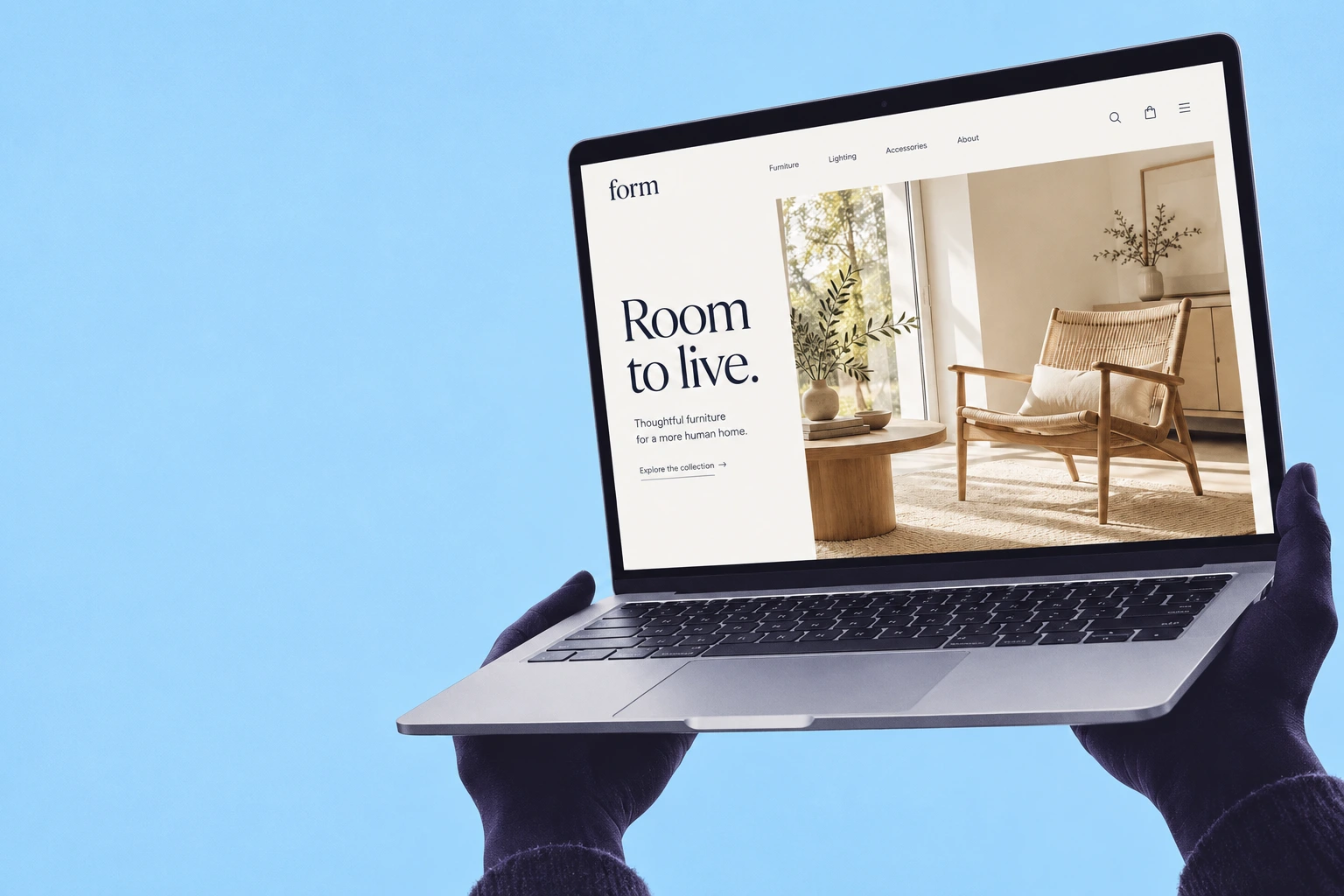 Hands holding a laptop showing the Form furniture website